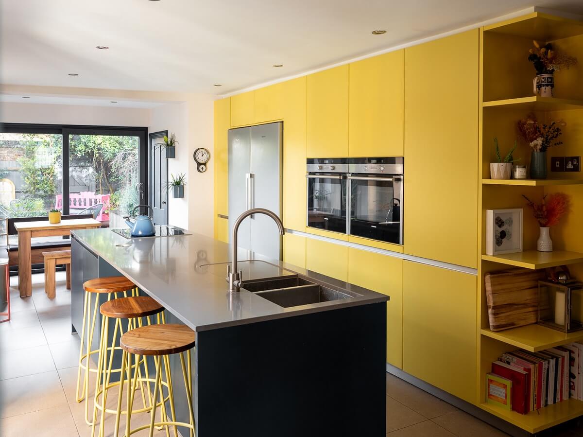 yellow-floor-to-ceiling-kitchen-cabinets-island-with-bar-stools-nordroom