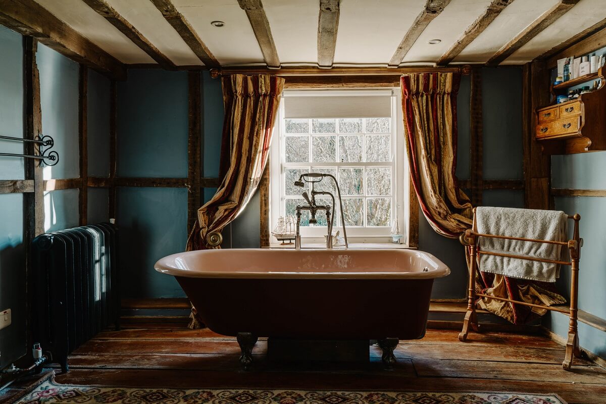 bathroom blue walls wooden beams freestanding bath historic english country house nordroom