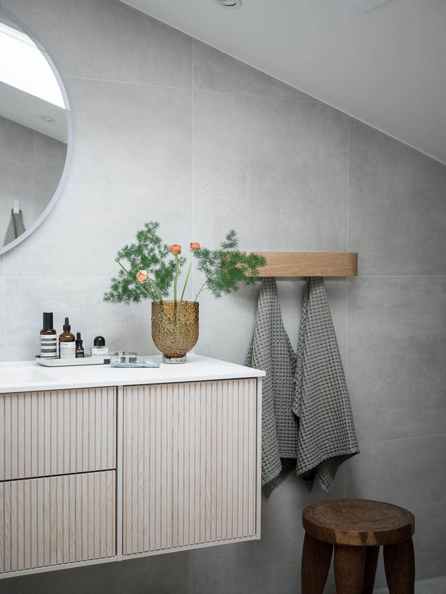bathroom slanted ceiling gray walls ribbed vanity cabinet nordroom