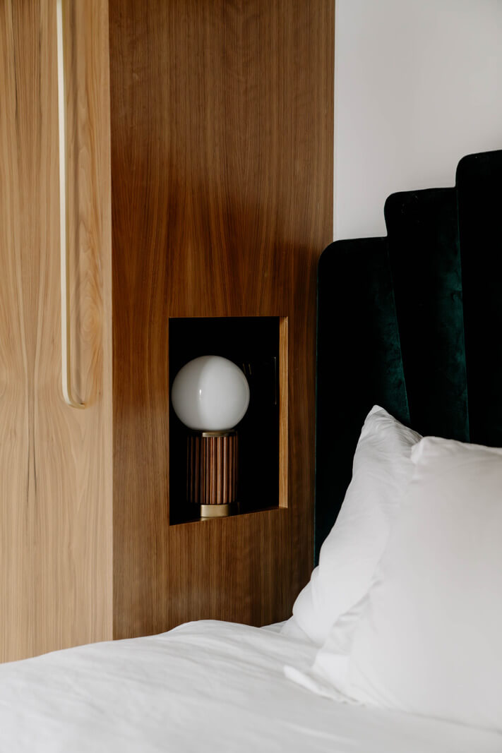 bed light fitted in walnut cabinets green velvet headboard nordroom