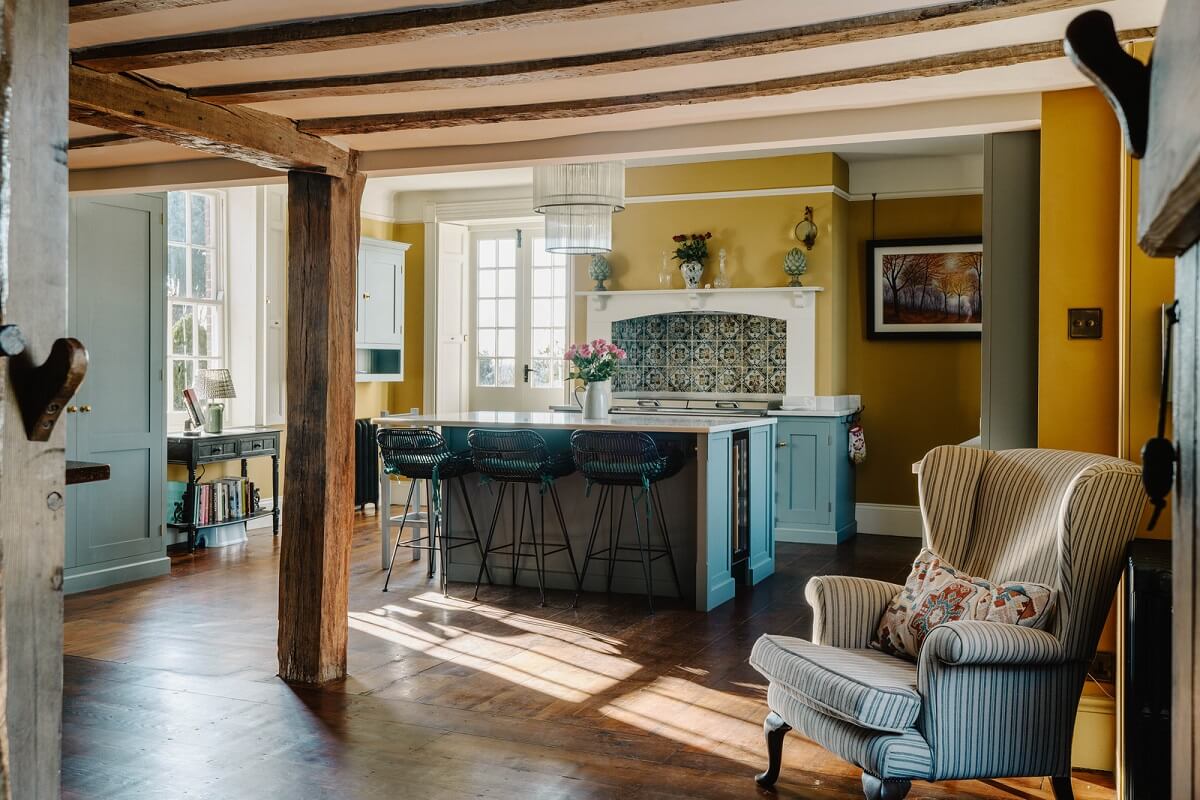 kitchen exposed wooden beams yellow walls nordroom