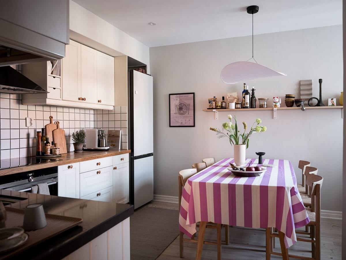 kitchen with dining table and pink striped tabe cloth nordroom