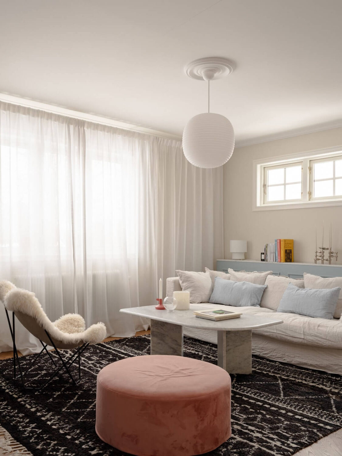 living room with rug and pink ottoman