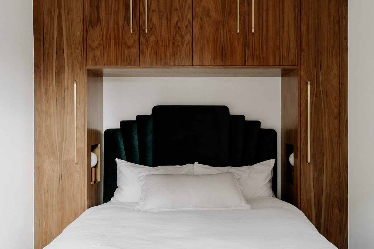 tiny bedroom walnut cabinets green velvet headboard