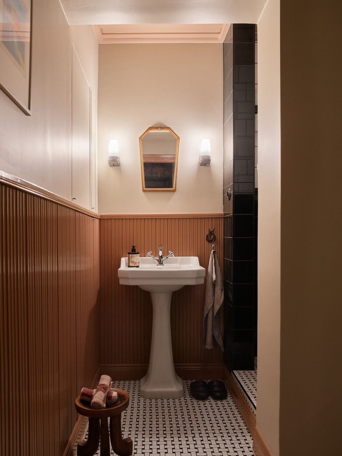 bathroom with light brown paneling and mosaic floor nordroom