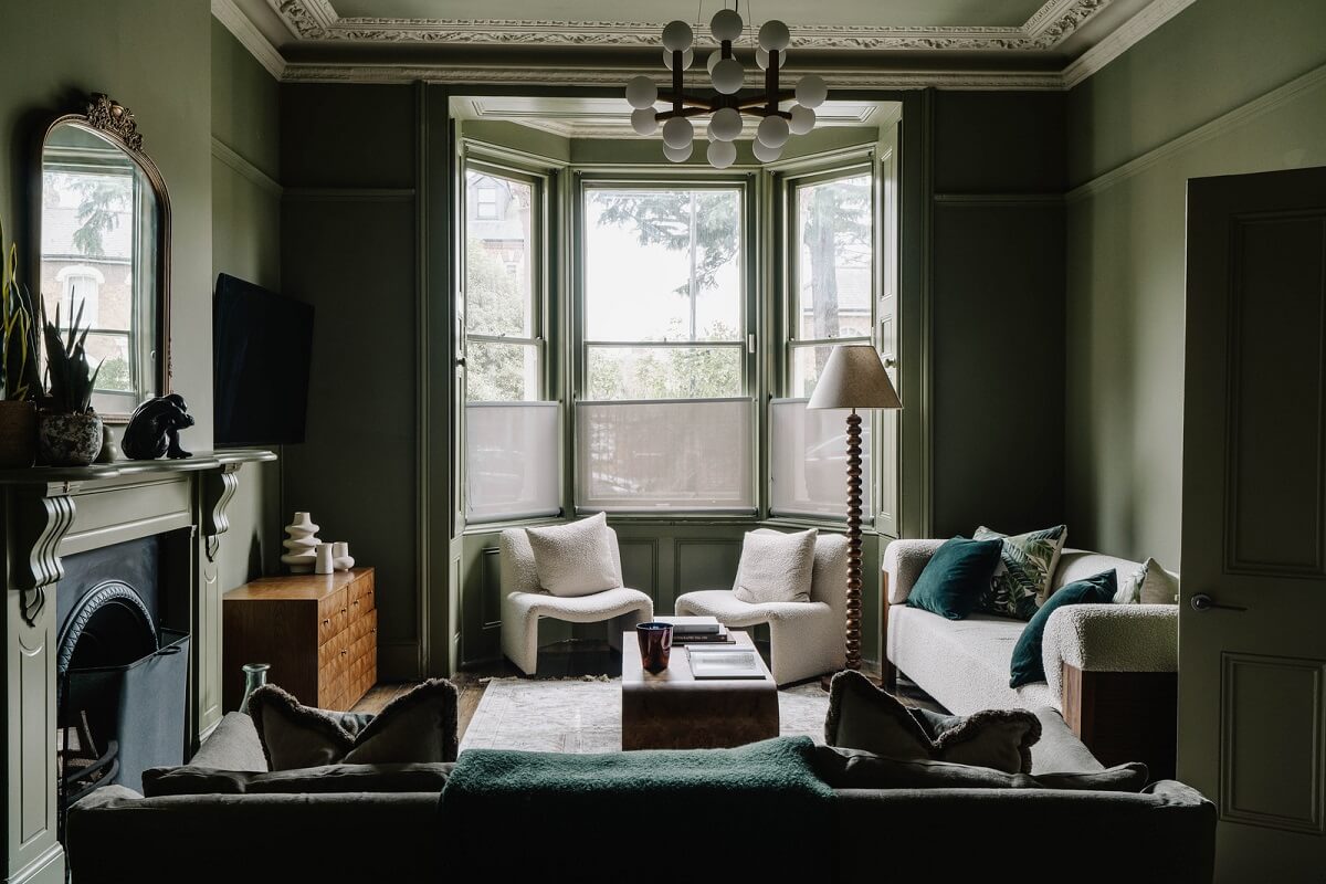 moody dark green living room with bay window and period features nordroom