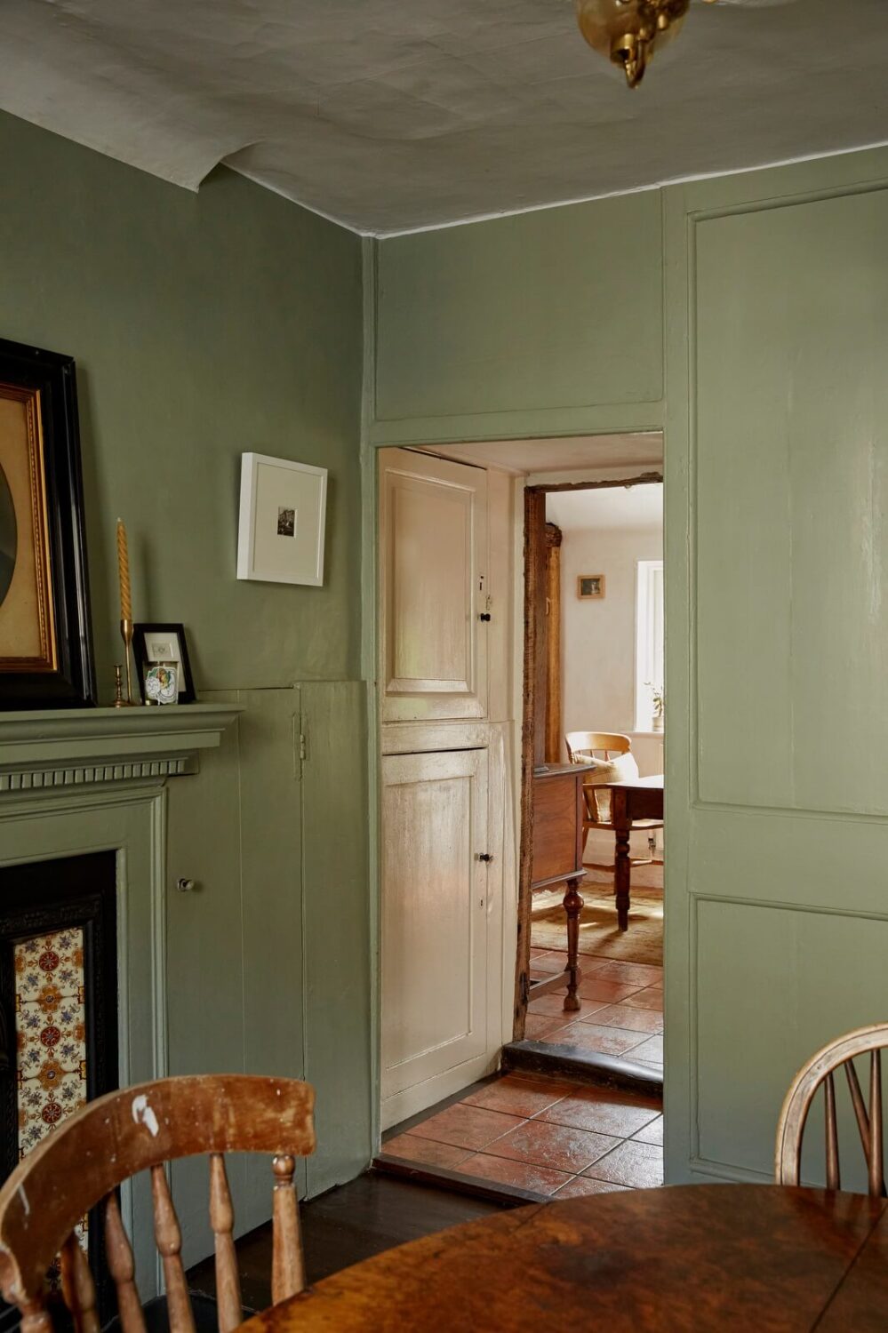 muted-green-walls-dining-room-with-fireplace-nordroom