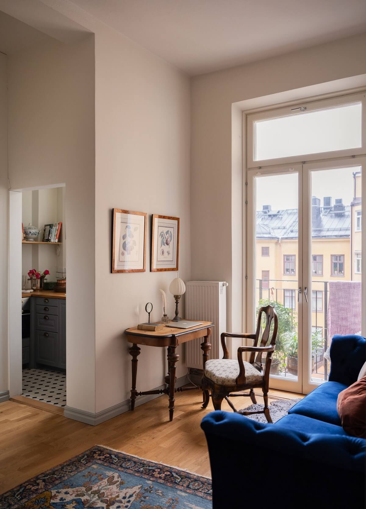 tiny living room with blue sofa and antique desk nordroom