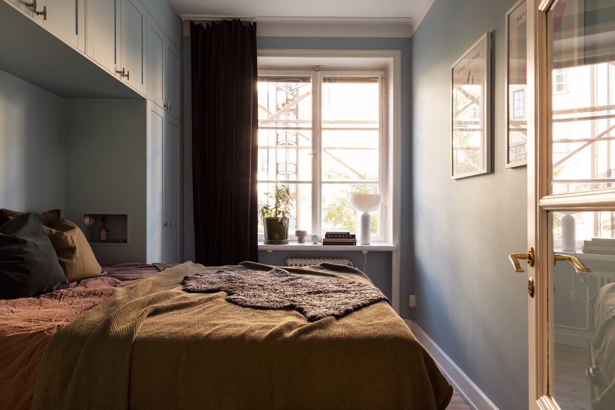 bedroom with custom wardrobes around the bed