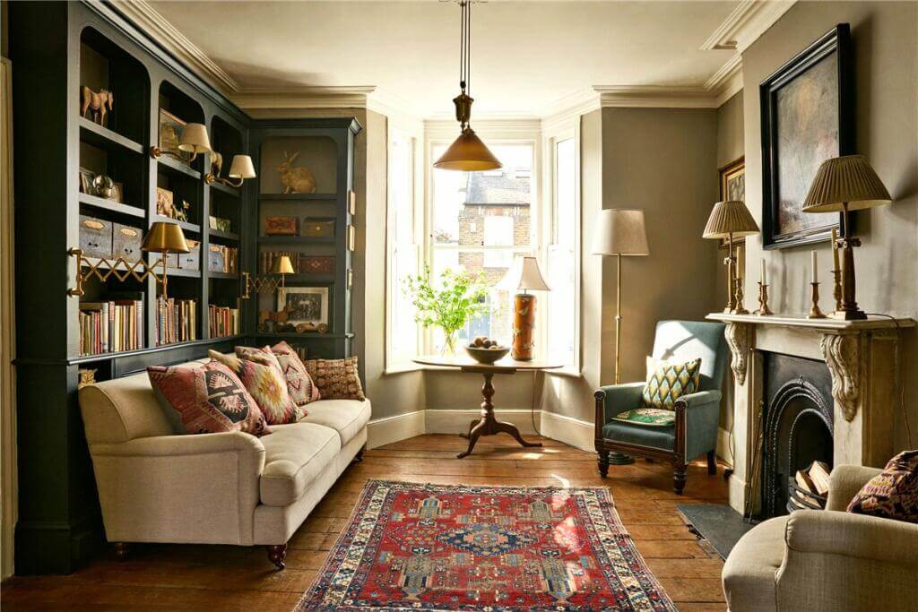 cozy living room with blue bookcases and bay window