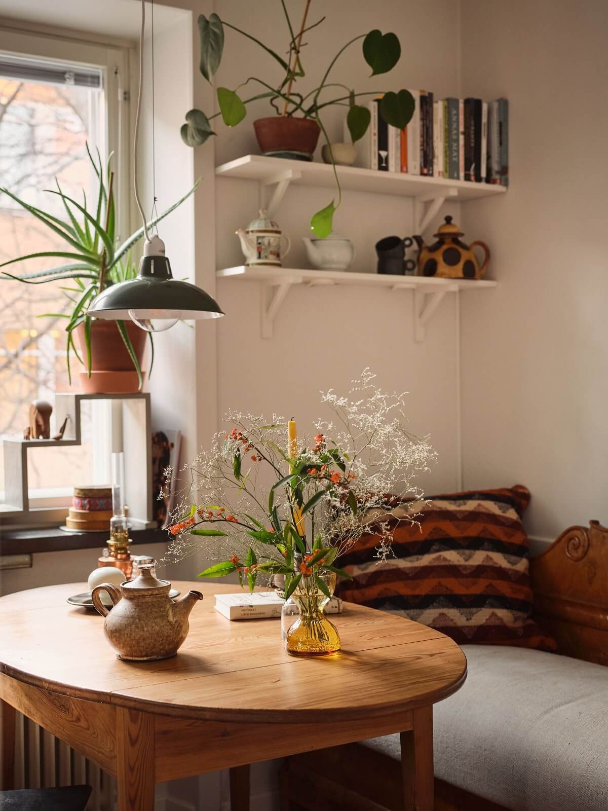 dining area with round wooden table and bench