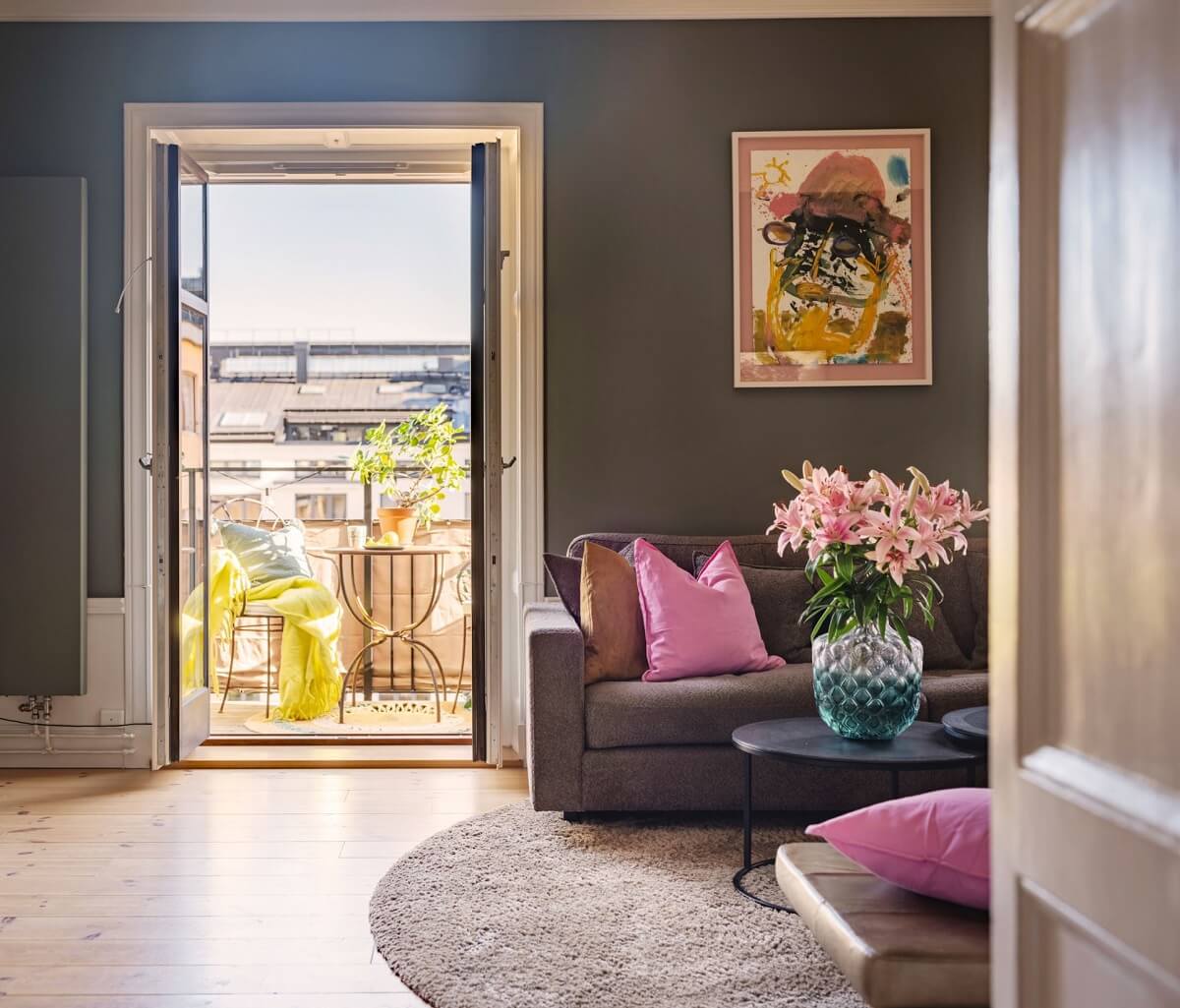 green living room with balcony and pink accents