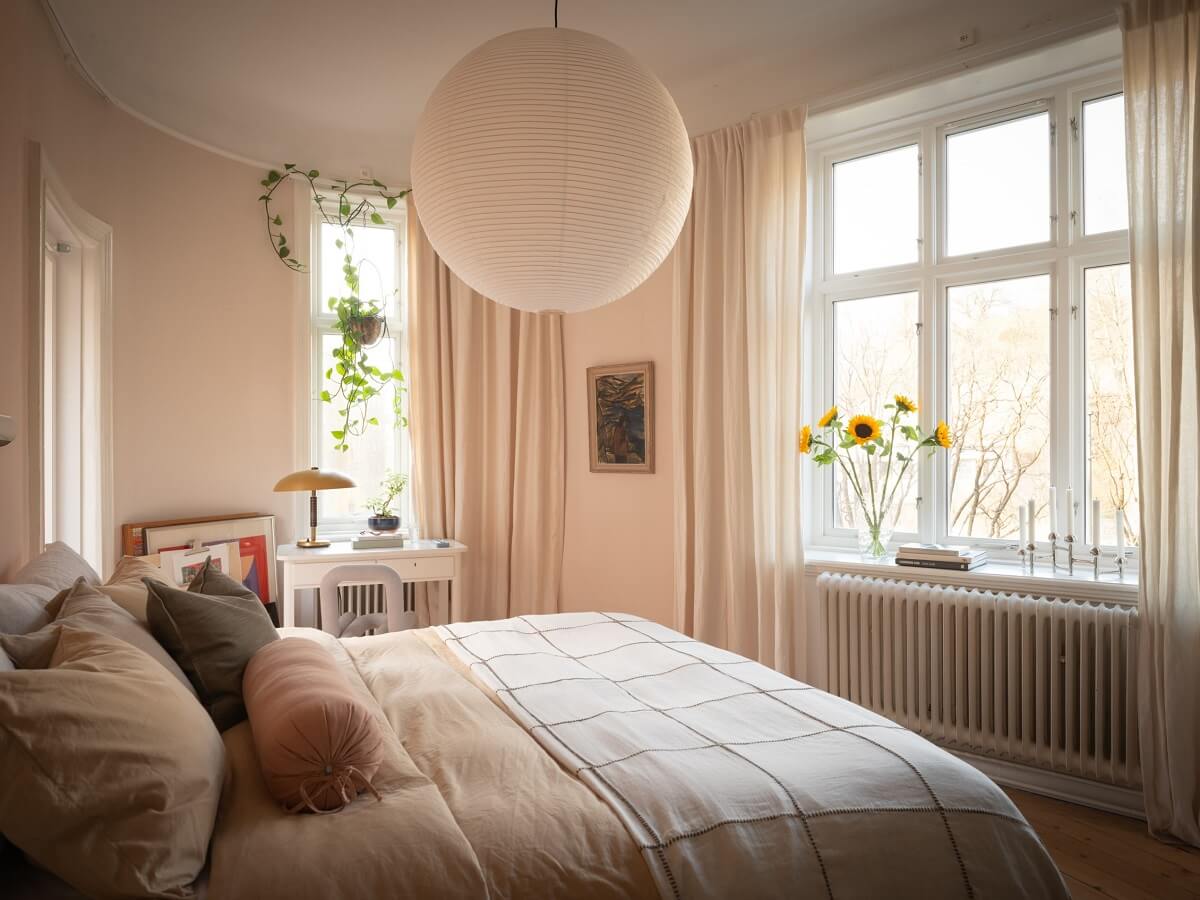 light bedroom with large windows and rounded wall