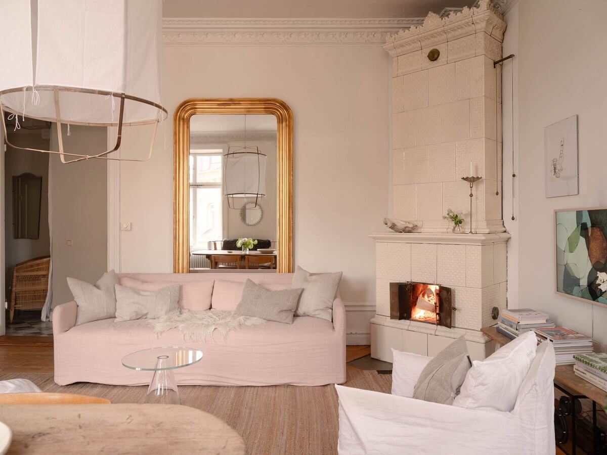 light living room with gilded mirror and fireplace