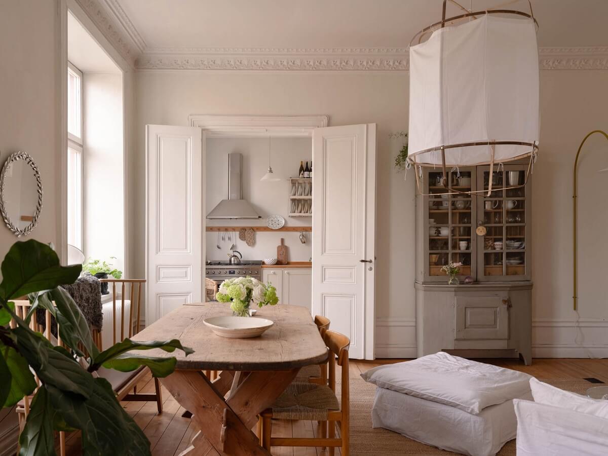 living room with double wooden doors to the kitchen