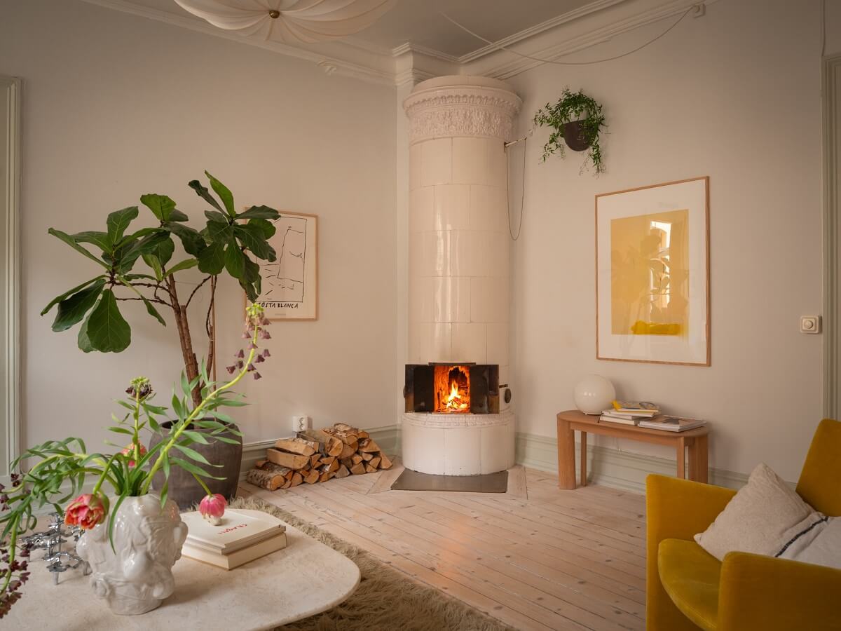 living room with ochre yellow chair and round fireplace