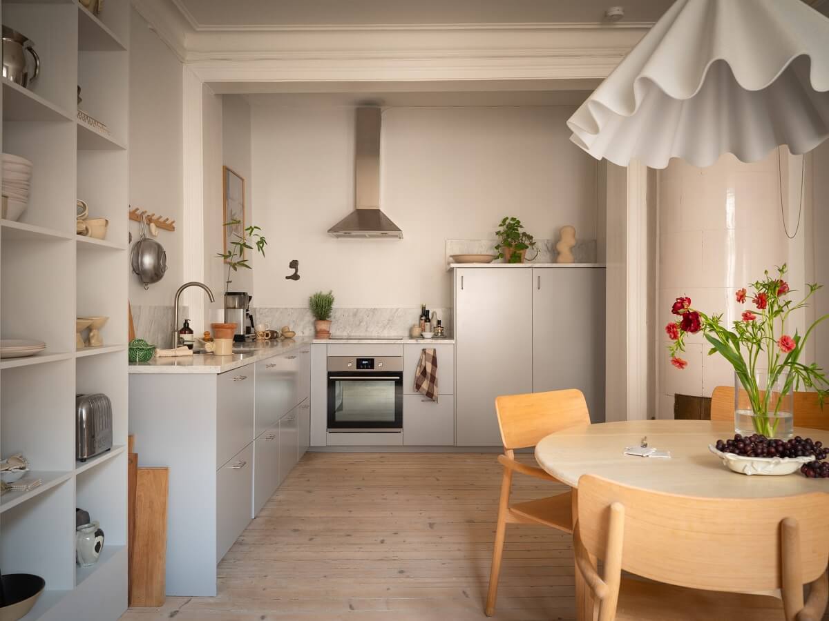 open kitchen with light gray cabinets and round dining table