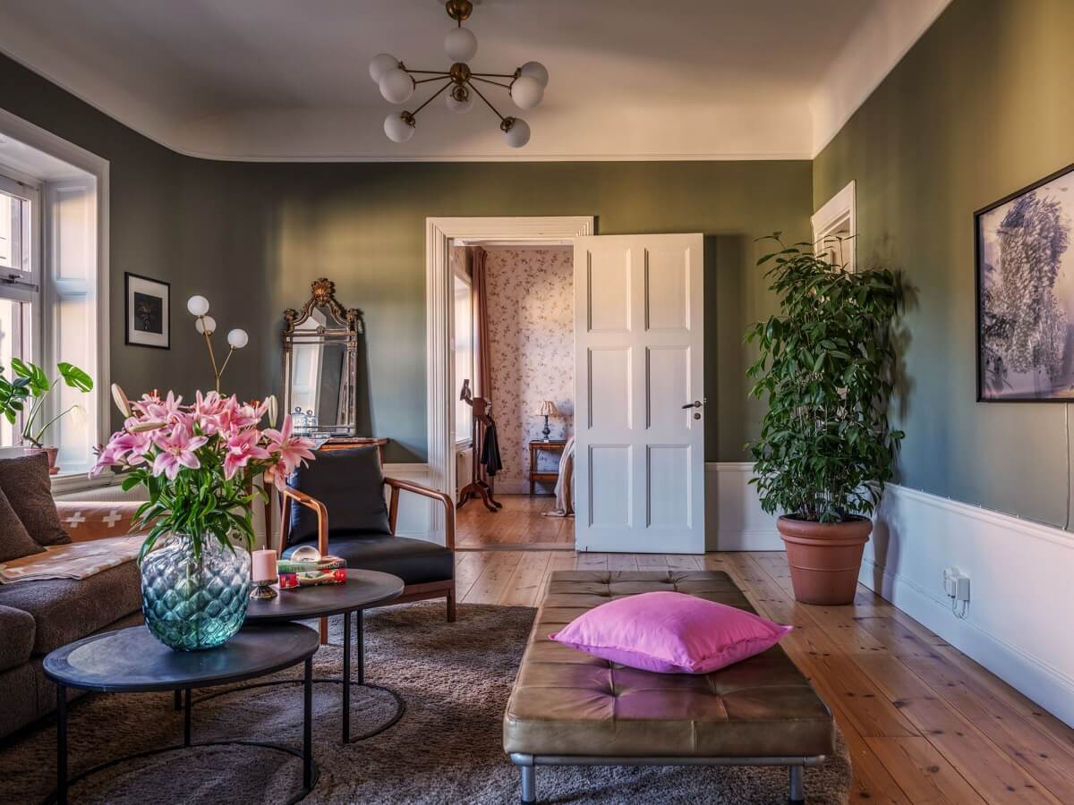 pink color accents in green living room