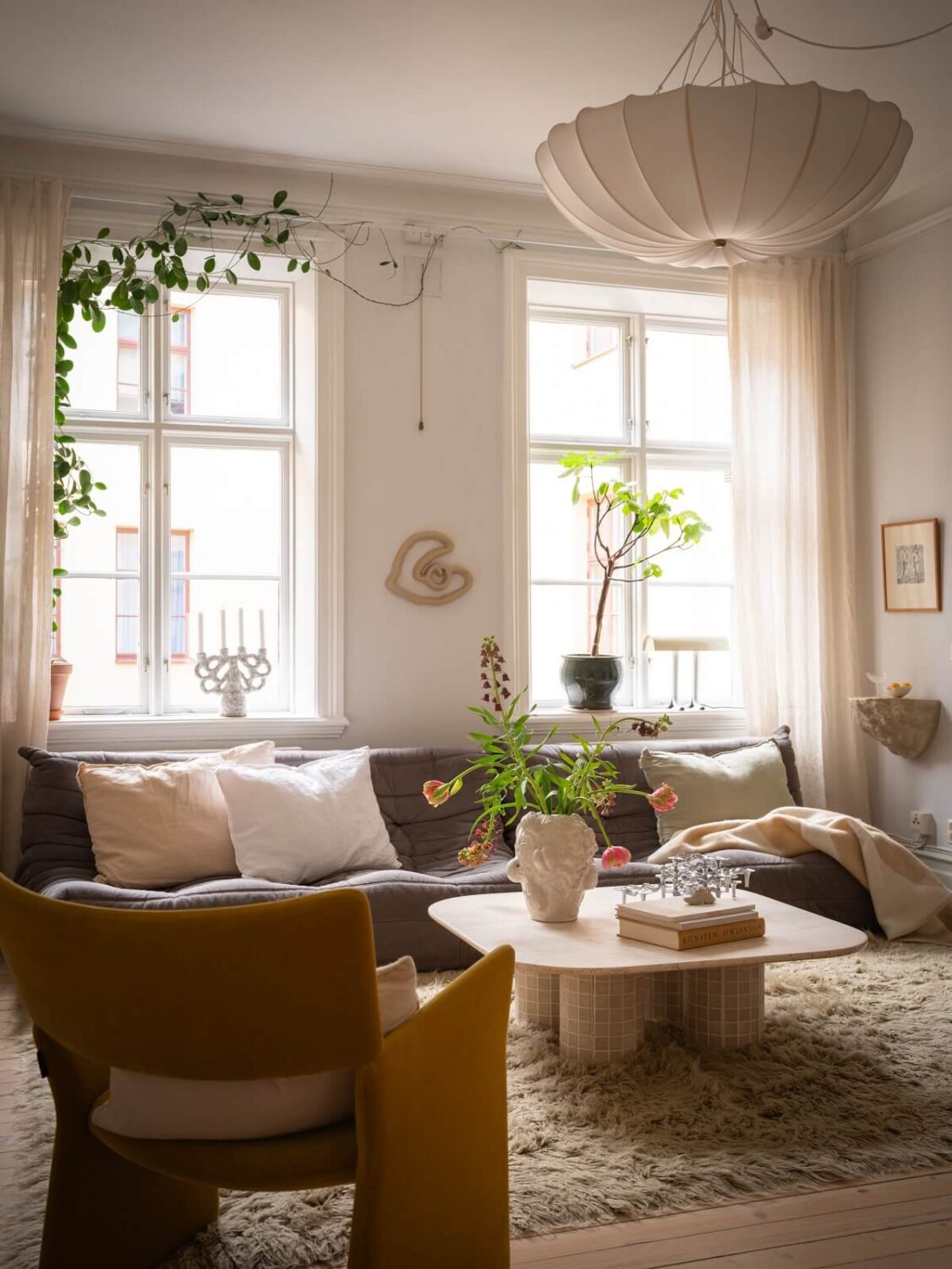 scandinavian living room with large rug and ligne roset sofa nordroom