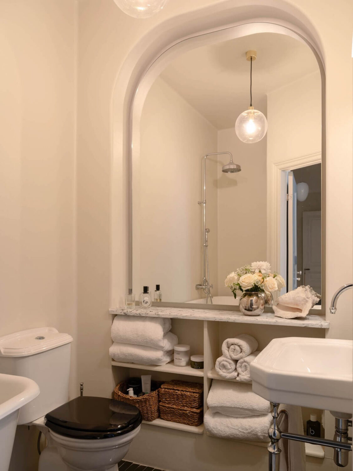 small bathroom with mirror and built in storage