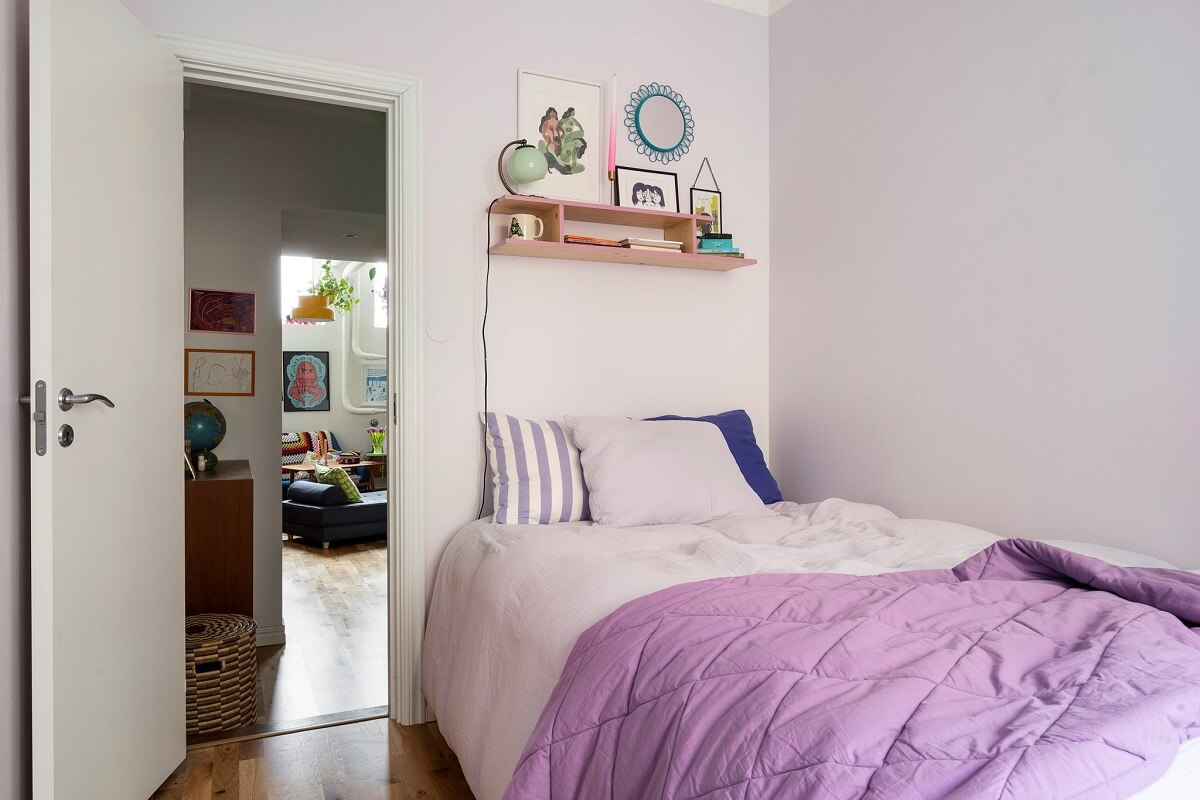 small bedroom with purple bedding