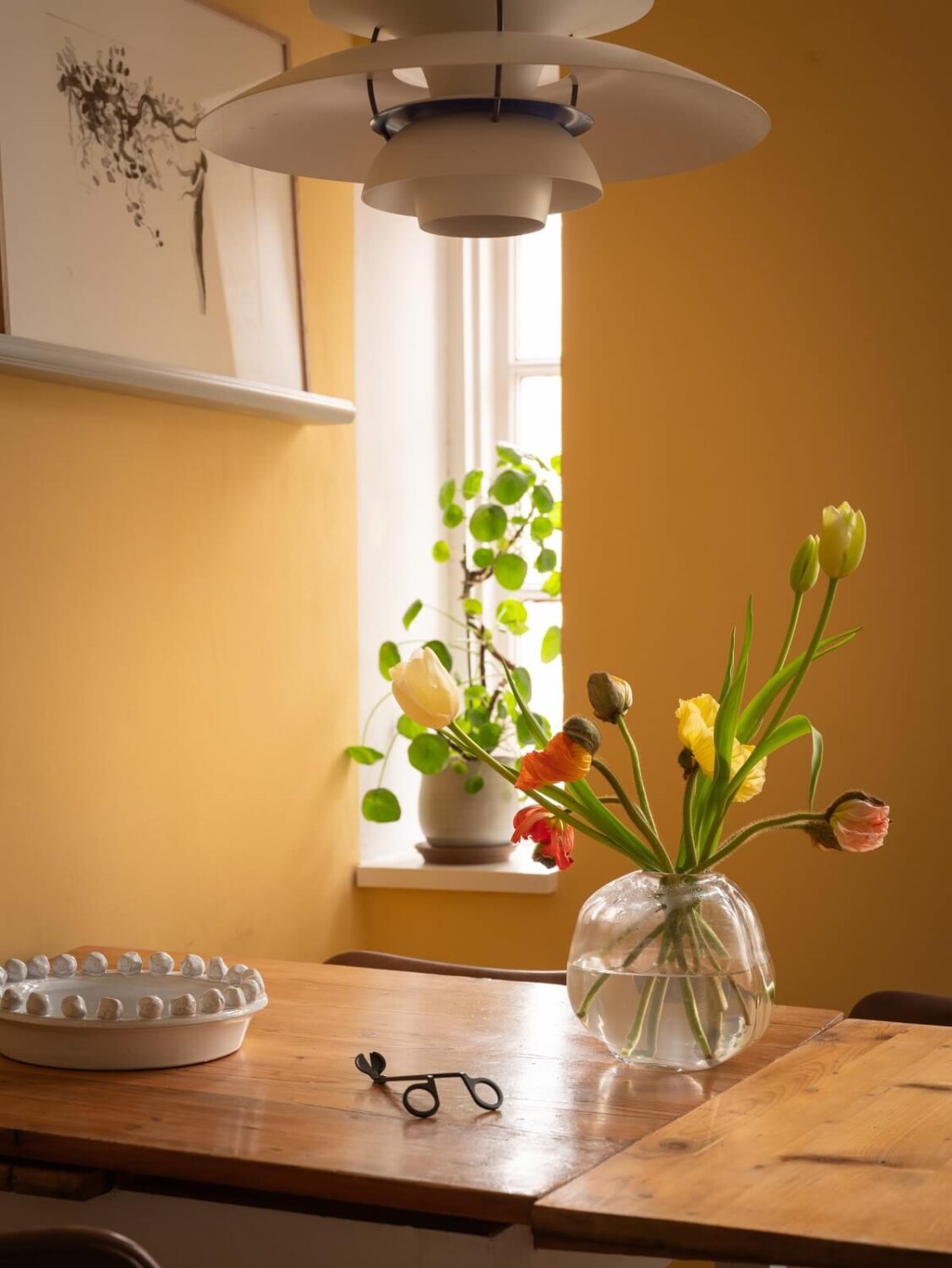 yellow wall and kitchen table with flowers