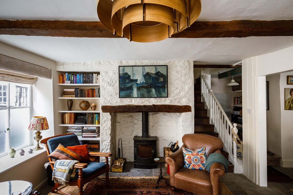 cottage living room with fireplace and exposed beams