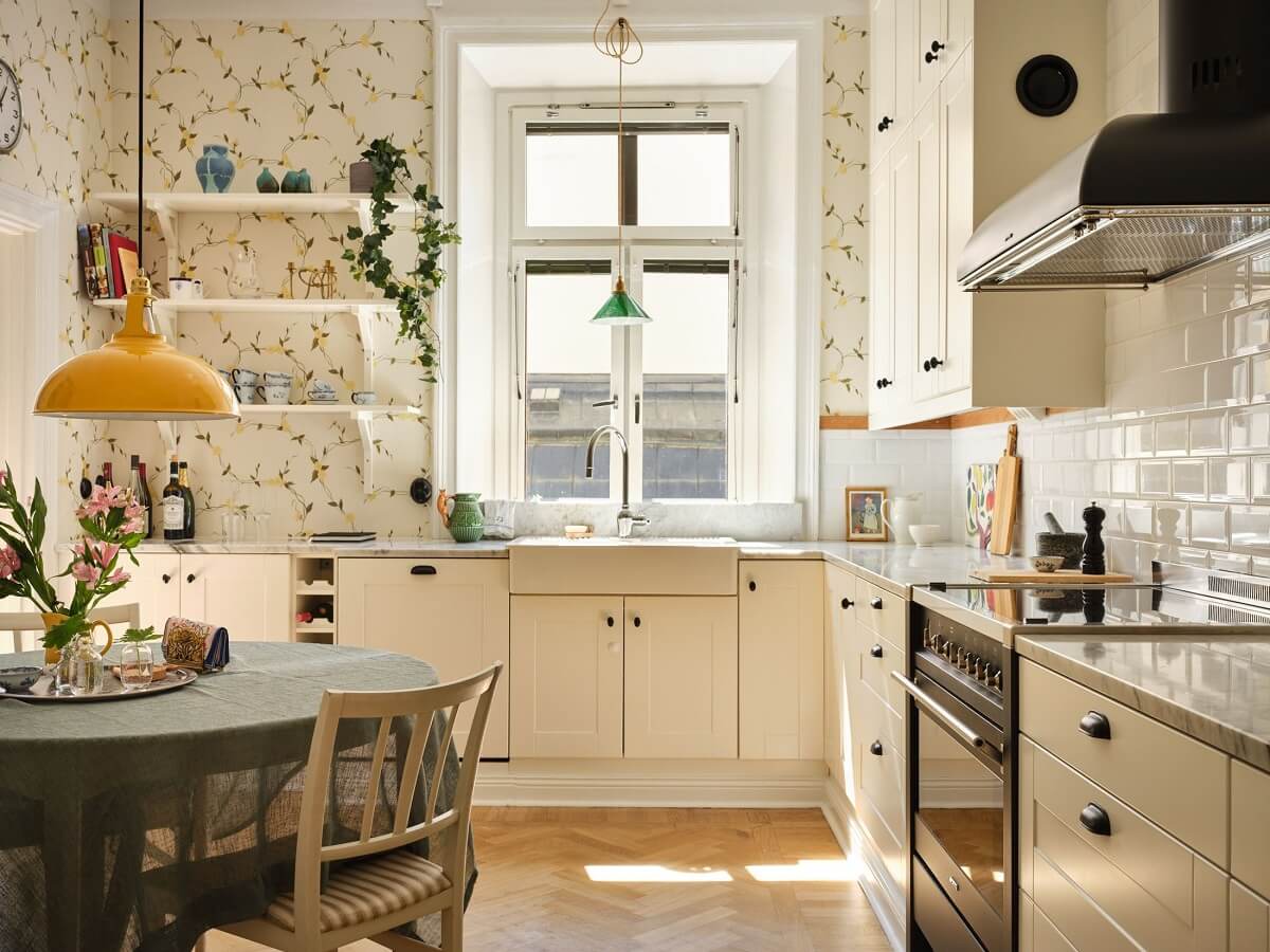 light kitchen with yellow floral wallpaper and round dining table nordroom