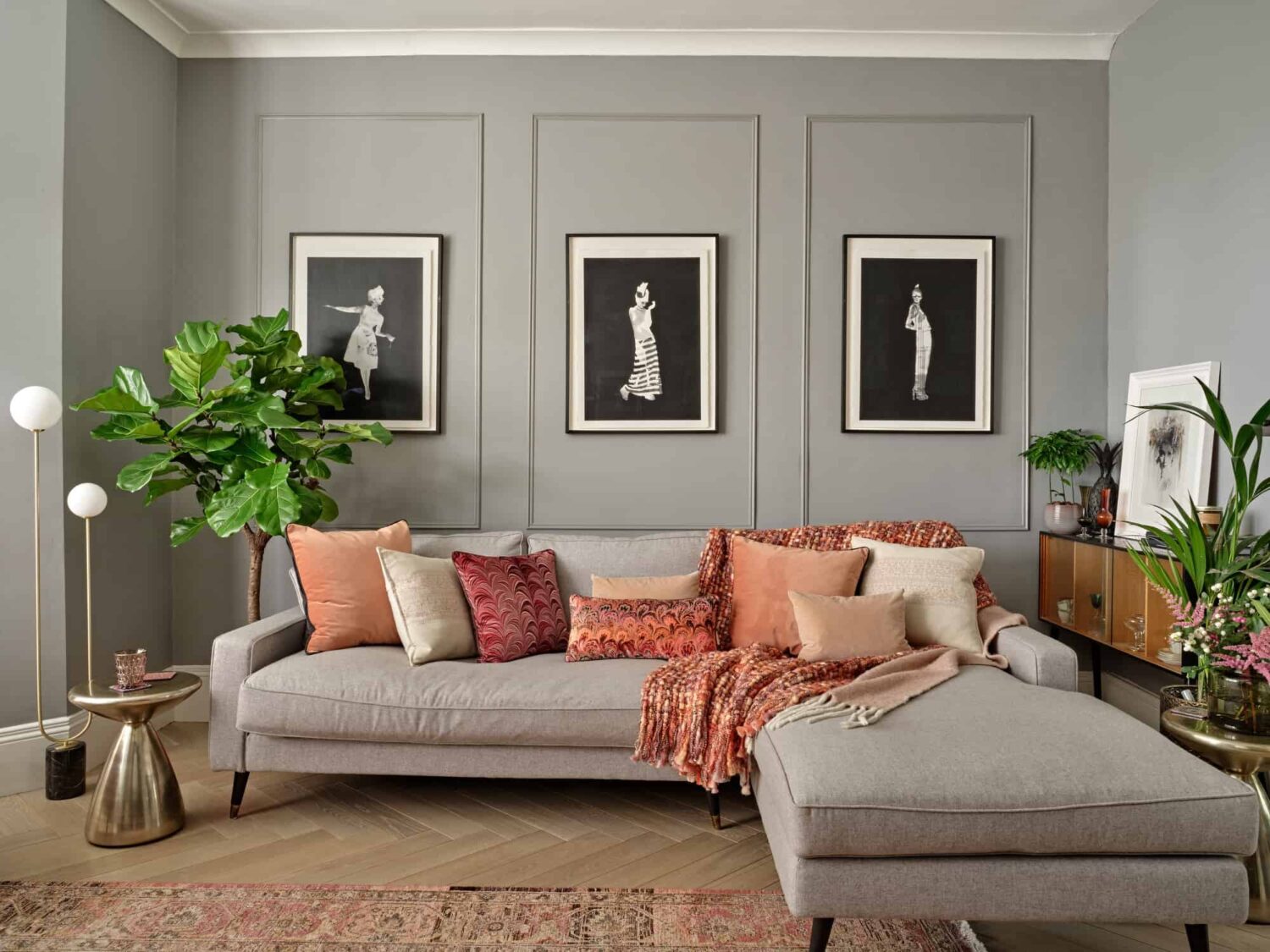 living room with light gray walls and orange pink cushions