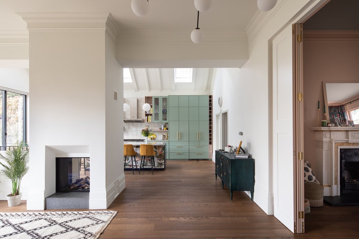 open plan living space with green kitchen