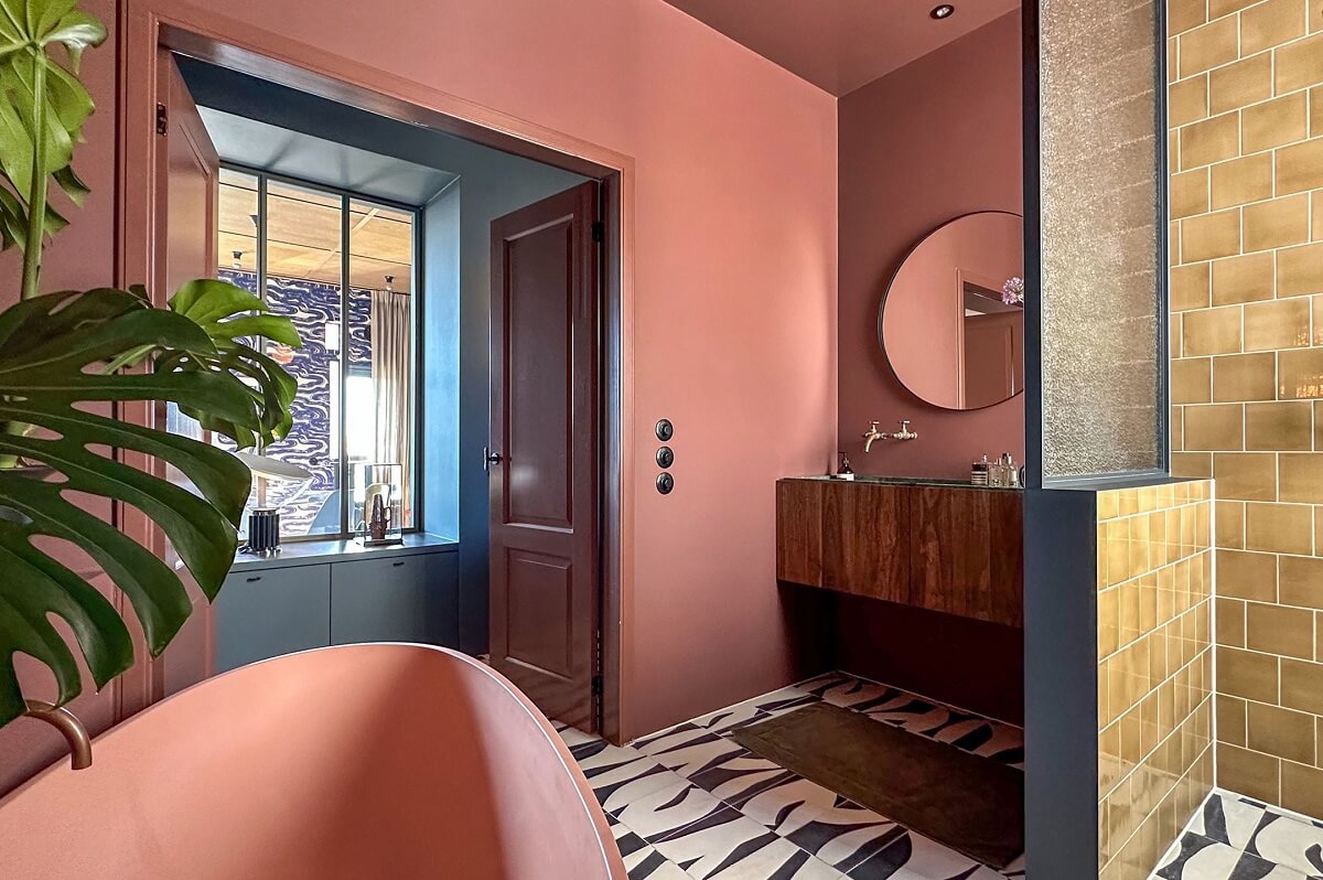 pink bathroom with walk in shower and graphic tiles