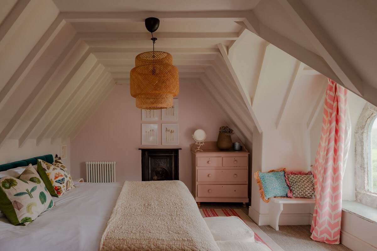 A Charming Gothic-Style Home with Original Details 27 attic bedroom with pink wall and dormer window nordroom