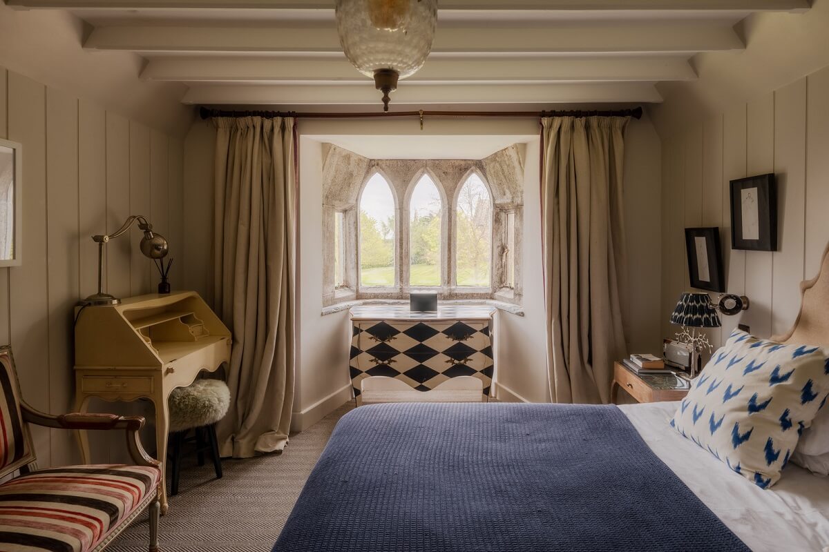 A Charming Gothic-Style Home with Original Details 22 bedroom with wooden beams nordroom