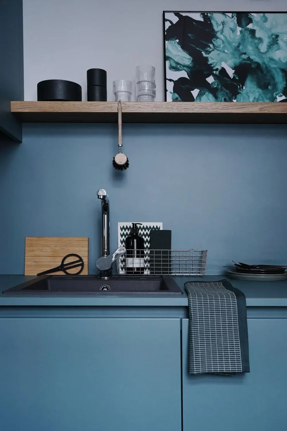 blue kitchen with wooden shelf