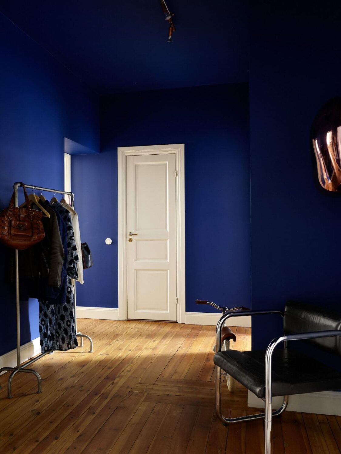 blue painted hallway with wooden floor nordroom