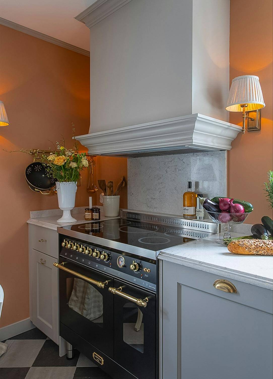 classic gray kitchen with orange wall luxurious summer house sweden nordroom A Classic and Luxurious Lakeside Home in Sweden