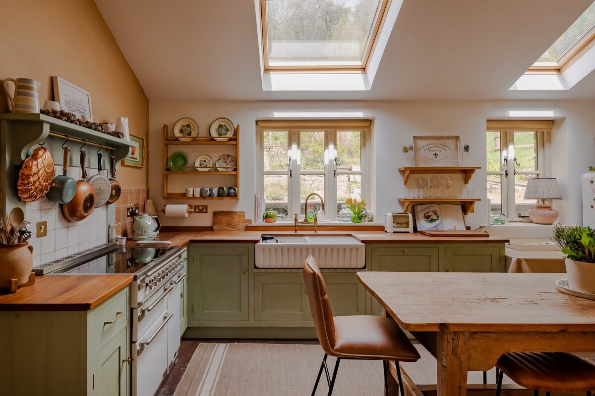 cottage kitchen with butler sink under window and farmhouse table nordroom