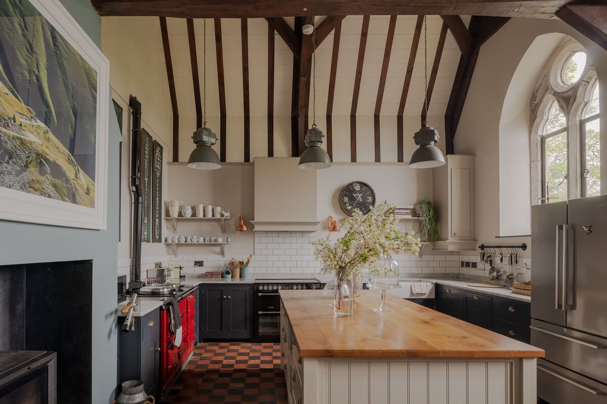 A Charming Gothic-Style Home with Original Details 6 kitchen with exposed wooden beams and checkerboard floor nordroom