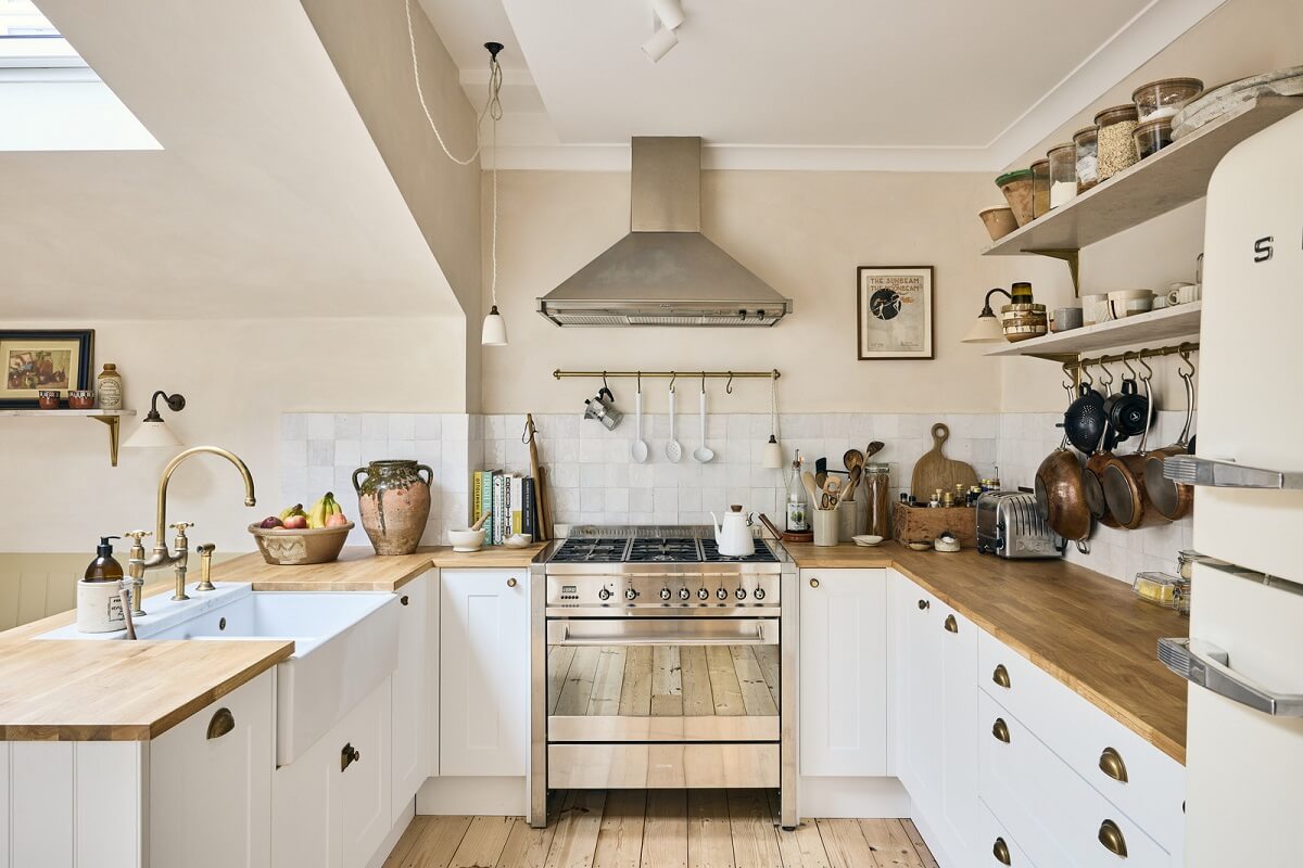 light cottage style kitchen with wooden worktop and shelves