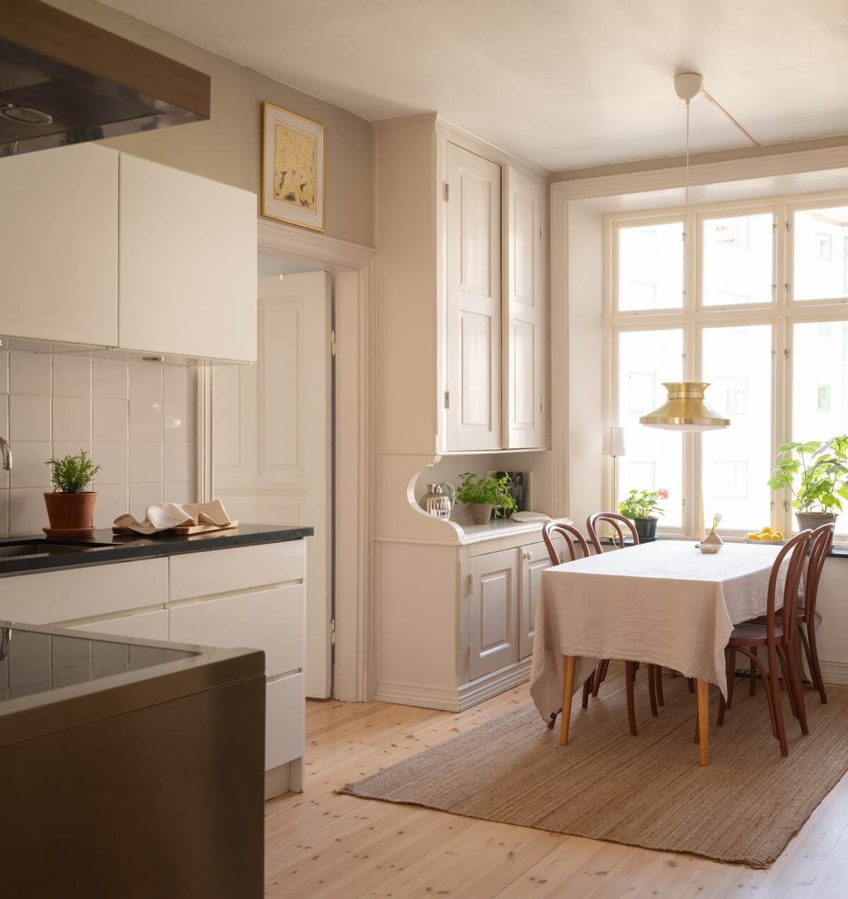 Light-Filled Rooms in a Historic Gothenburg Apartment 17 modern white kitchen with dining table