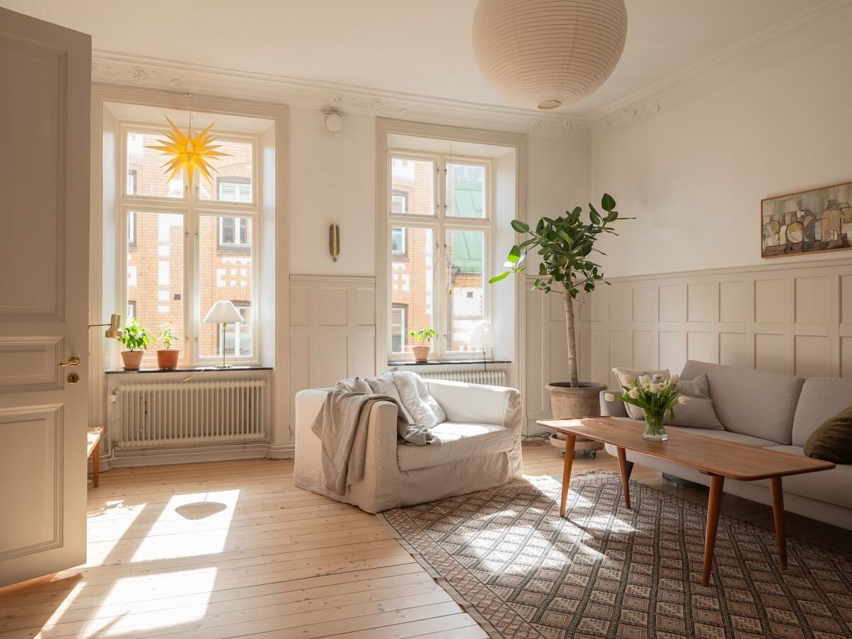 Light-Filled Rooms in a Historic Gothenburg Apartment 4 sunlight streaming in scandinavian living room