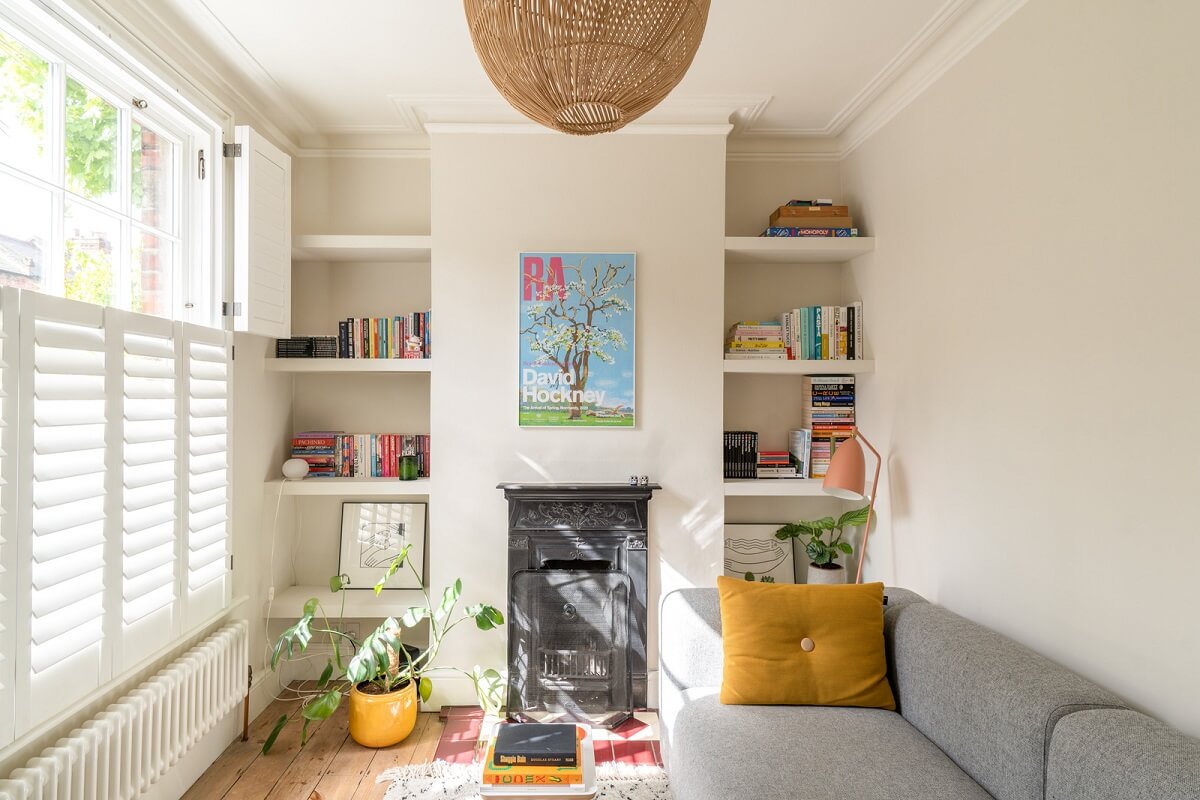 tiny living room with fireplace and built in shelves