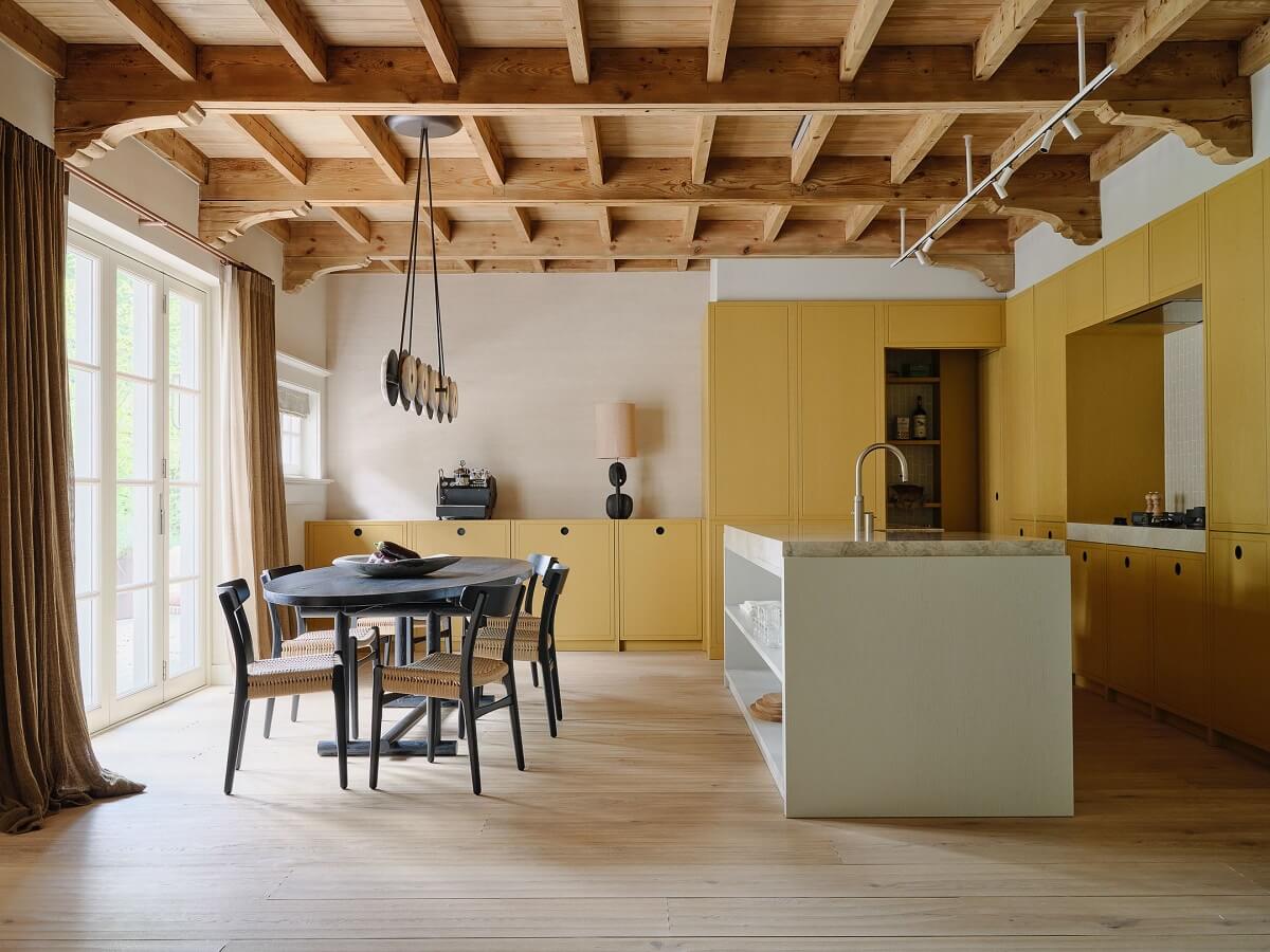 yellow kitchen cabinets and exposed wooden ceiling nordroom