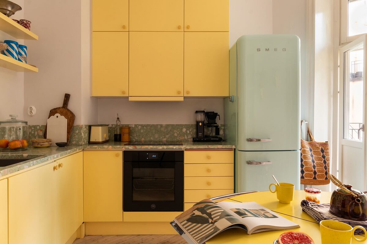 yellow kitchen cabinets and mint green fridge