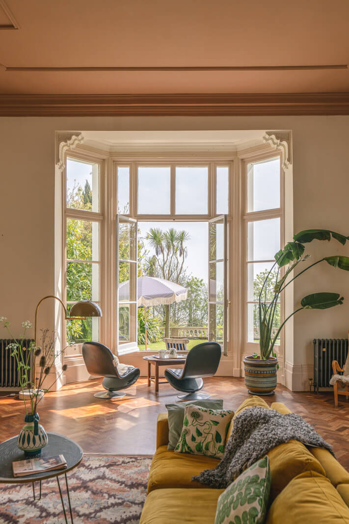 yellow sofa and large bay window in living room