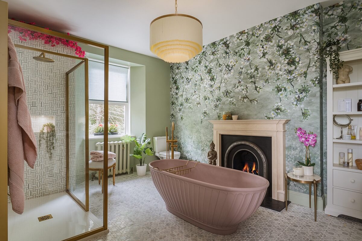 bathroom with pink bath fireplace and wallpaper
