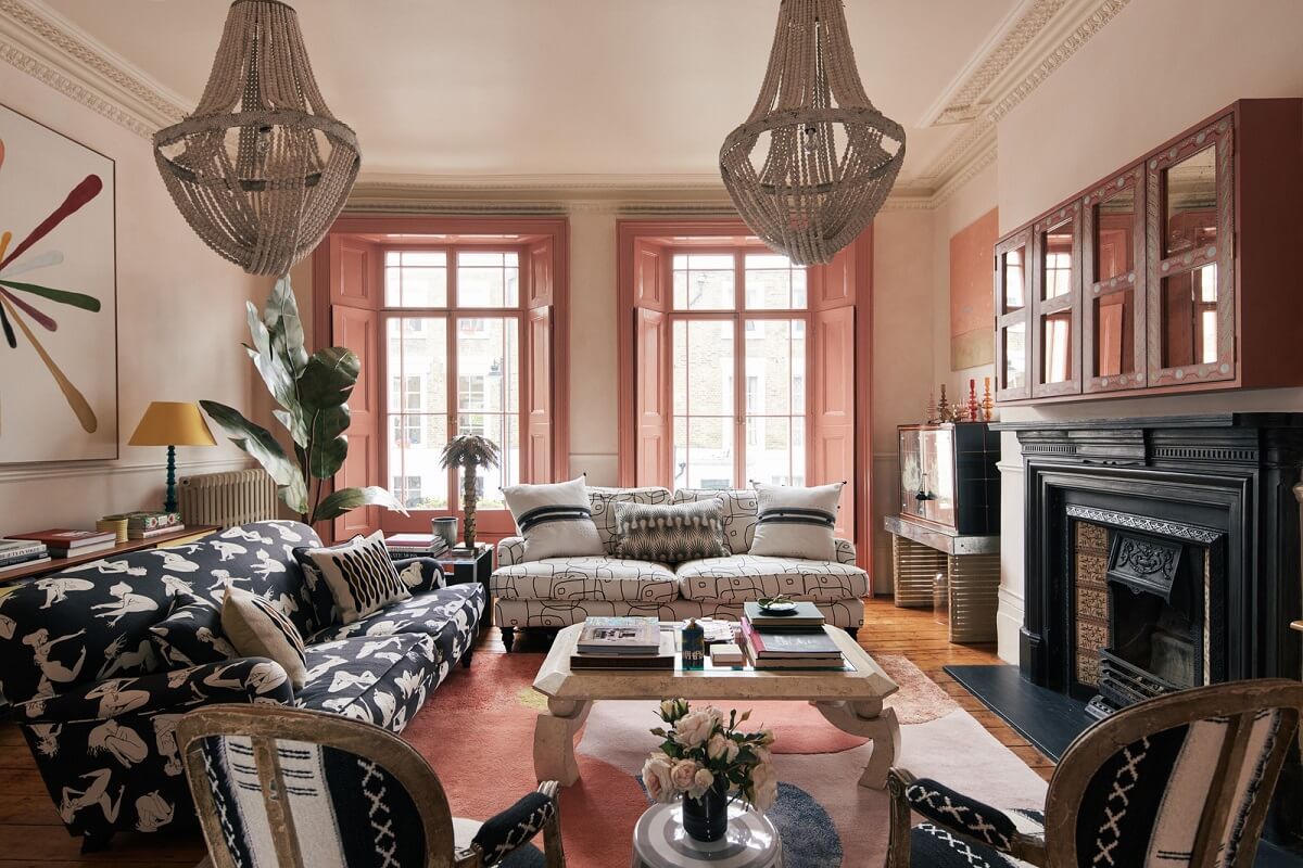 sitting room with pink shutters and black fireplace