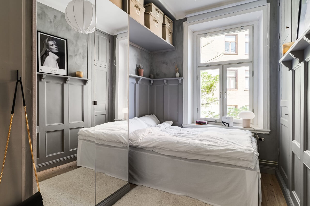 small gray bedroom with mirror wardrobe
