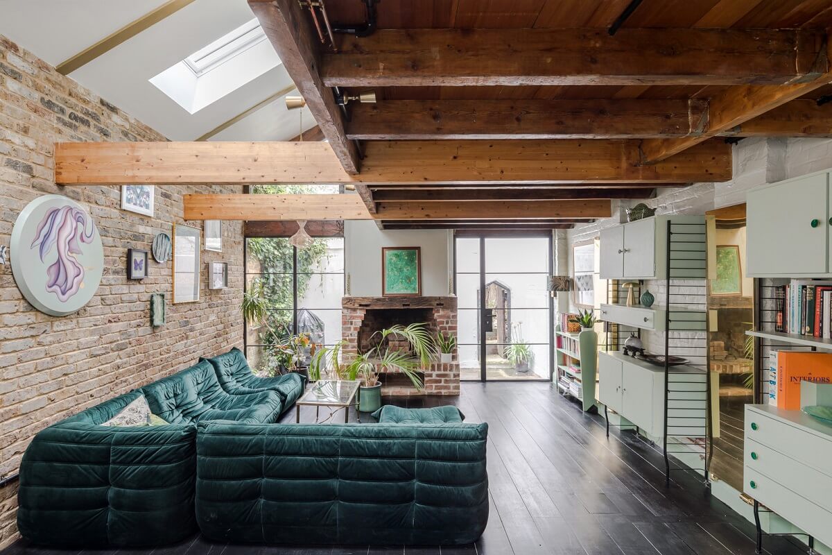 Exposed Materials and Green Tones in a London Stable Conversion 1 living space brick wall skylights green togo sofa