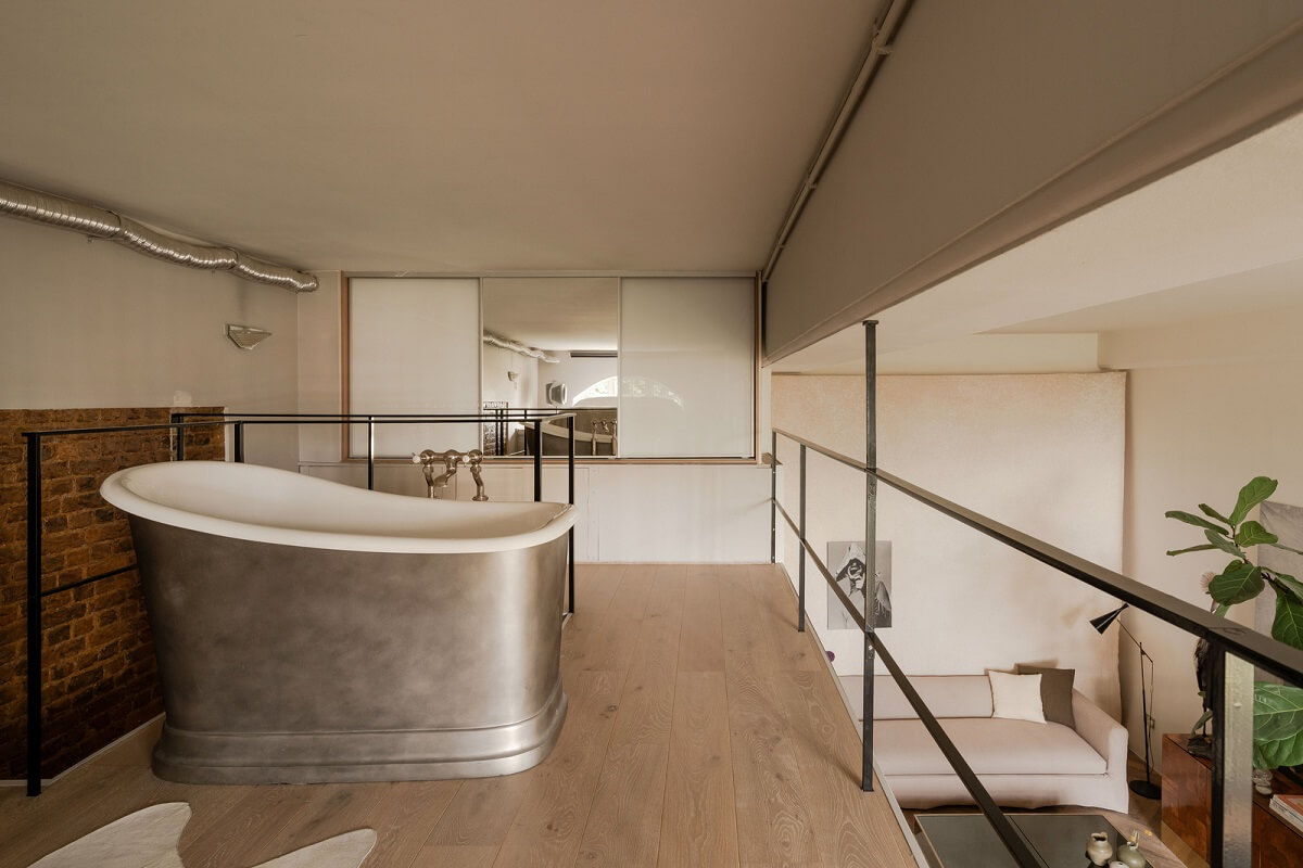 loft bedroom with freestanding bath